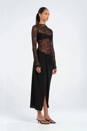Colton Midi Dress Black by Benni – A trendy high-neck lace dress with open back, built-in bralette, and soft jersey skirt with thigh-high split, perfect for elegant evening occasions.