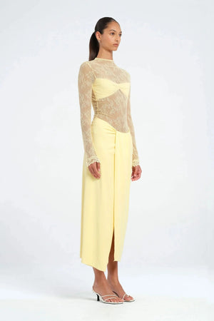 Colton Midi Dress Butter by Benni – A trendy high-neck lace dress with elegant open back, built-in bralette, and soft jersey skirt with thigh-high split, perfect for sophisticated daytime and evening events