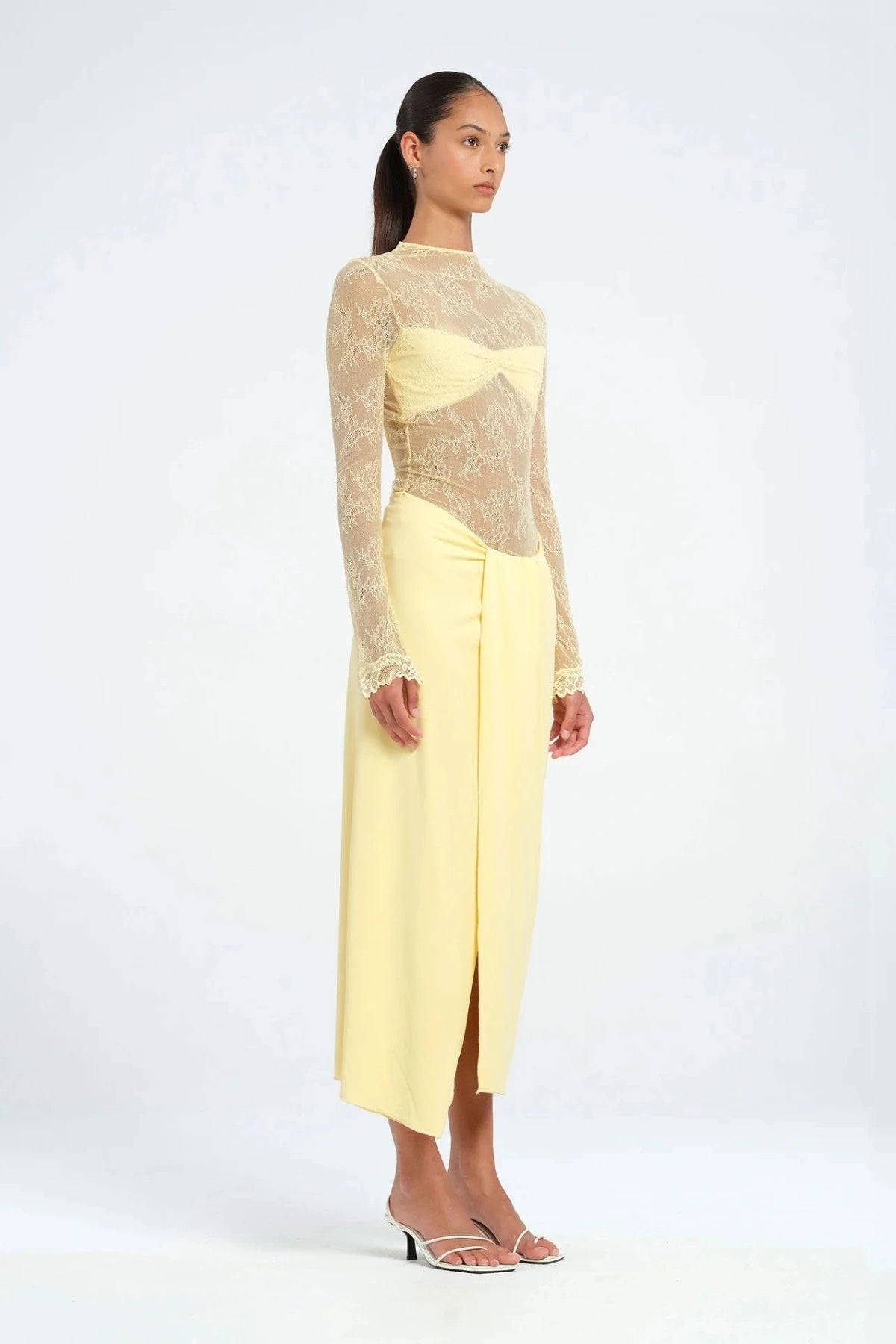Colton Midi Dress Butter by Benni – A trendy high-neck lace dress with elegant open back, built-in bralette, and soft jersey skirt with thigh-high split, perfect for sophisticated daytime and evening events