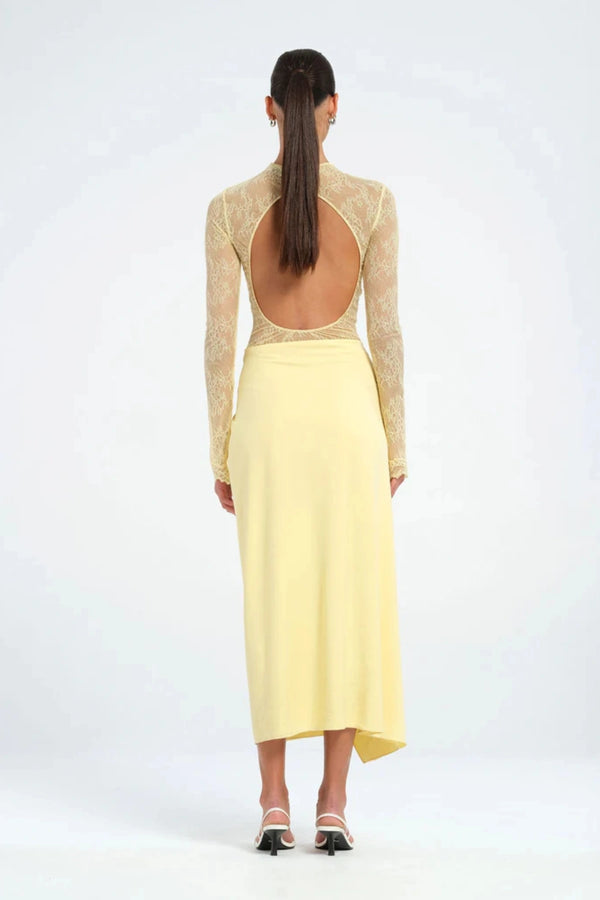 Colton Midi Dress Butter by Benni – A trendy high-neck lace dress with elegant open back, built-in bralette, and soft jersey skirt with thigh-high split, perfect for sophisticated daytime and evening events