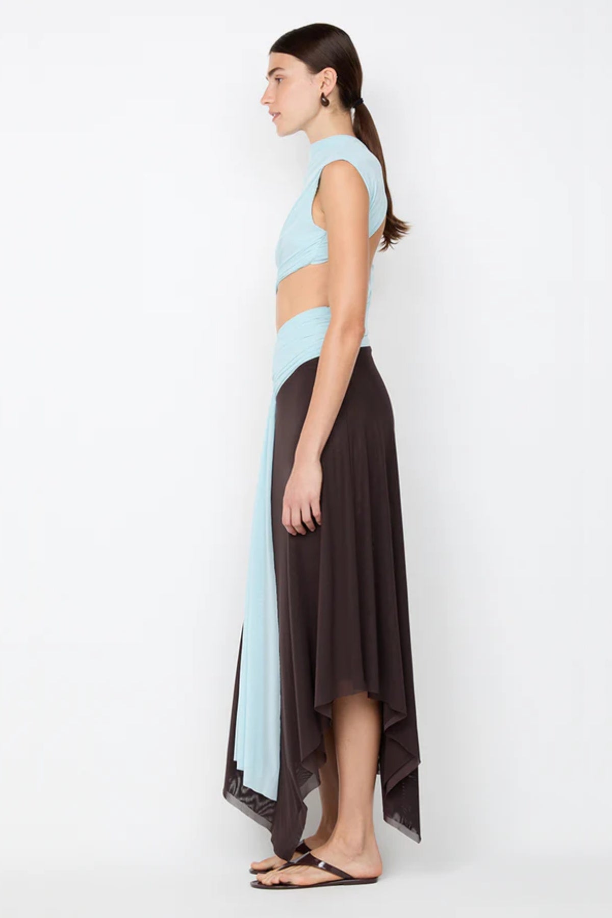 Conni Asym Midi Dress by Bec + Bridge, a two-tone mesh silhouette with cut-out waist, gathered sash, and raw hem for sculptural evening allure.