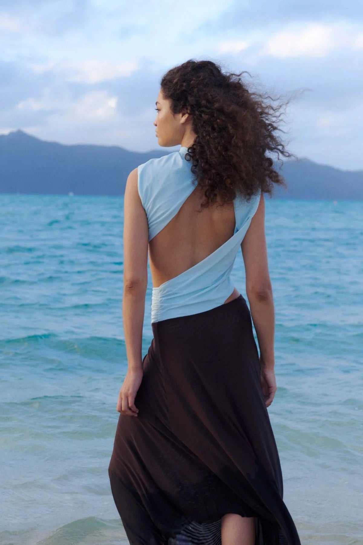 Conni Asym Midi Dress by Bec + Bridge, a two-tone mesh silhouette with cut-out waist, gathered sash, and raw hem for sculptural evening allure.