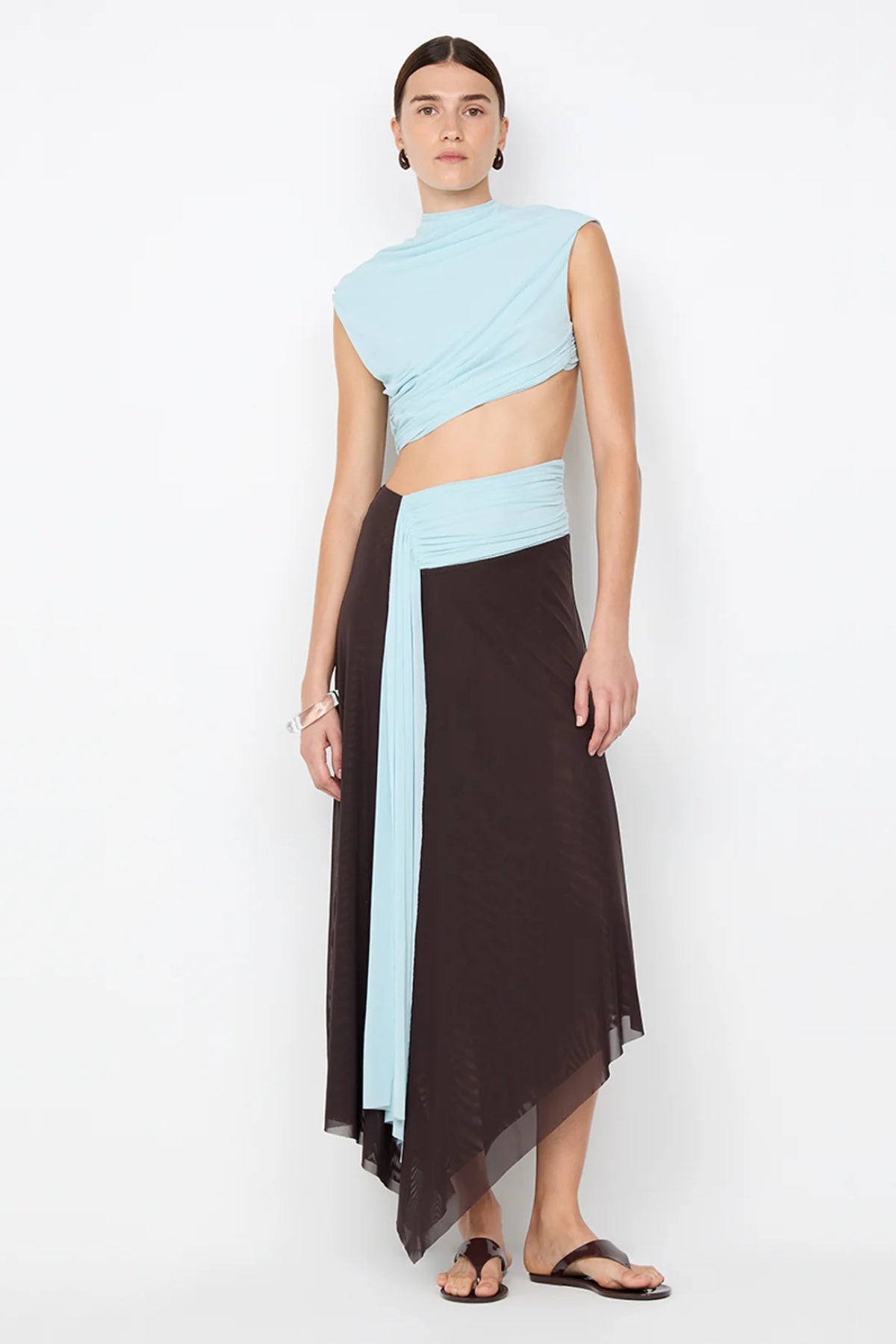 Conni Asym Midi Dress by Bec + Bridge, a two-tone mesh silhouette with cut-out waist, gathered sash, and raw hem for sculptural evening allure.