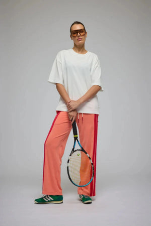 Corfu Terry Pant in Bougainvillea Pink by Araminta James, relaxed wide-leg cotton terry pants with contrasting red velour side panels, elasticated waistband, and side pockets for effortless coastal styling.