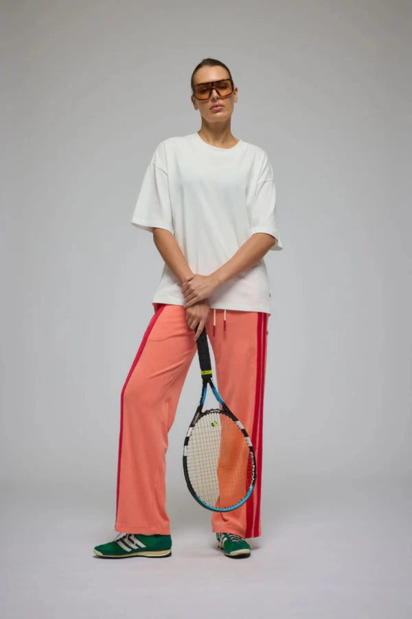 Corfu Terry Pant in Bougainvillea Pink by Araminta James, relaxed wide-leg cotton terry pants with contrasting red velour side panels, elasticated waistband, and side pockets for effortless coastal styling.