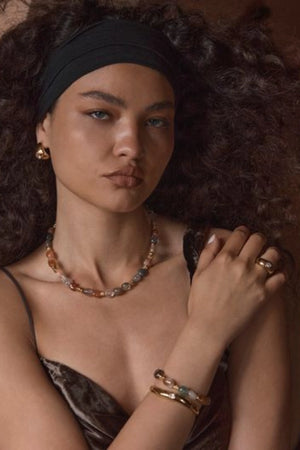 Corniglia Bracelet Gold by Amber Sceats, gold-plated cuff with cubic zirconia crystal detail, a trendy piece perfect for chic events or everyday elegance.