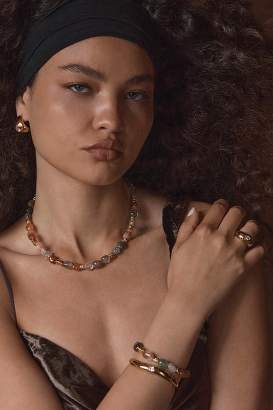 Corniglia Ring Gold by Amber Sceats, sculptural curved band with cubic zirconia crystal, a trendy piece perfect for everyday elegance or chic sets.