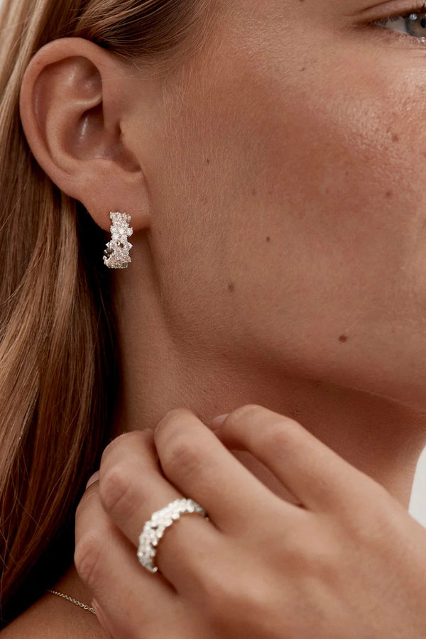 Crystal Dust Hoops by By Charlotte – 18k gold plated hoop earrings with scattered cubic zirconia stones.