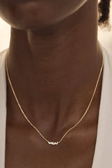 Crystal Dust Necklace by By Charlotte – 18k gold vermeil butterfly wing pendant with cubic zirconia stones.