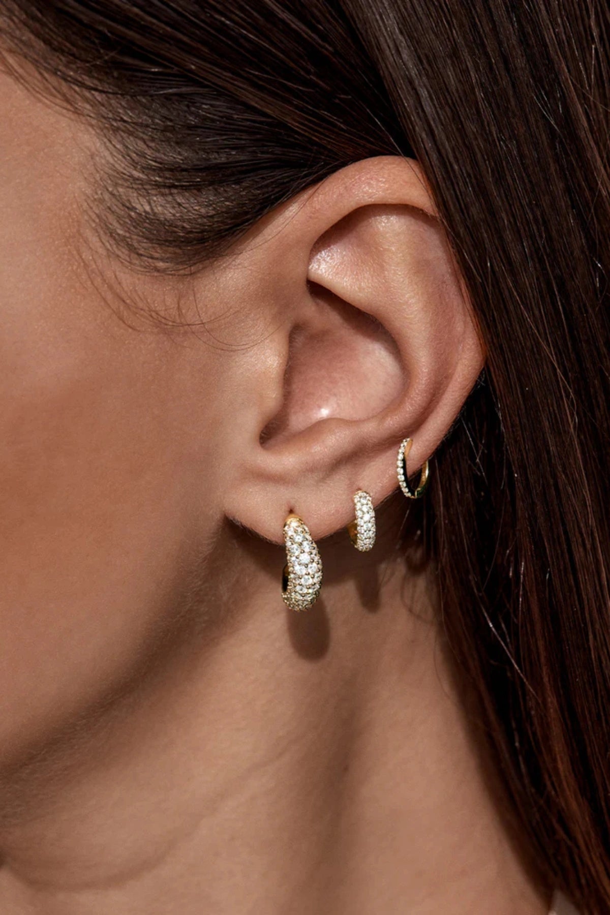 Crystal Wave Hoops by by charlotte — gold vermeil wave-shaped hoops with pavé crystals, perfect for elegant event styling.
