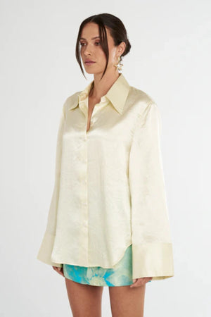 Cuff Shirt Butter by Summi Summi, soft butter-hued shirt with a structured collar and oversized flared cuffs. Lightweight acetate fabric for effortless sophistication.