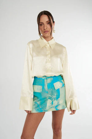 Cuff Shirt Butter by Summi Summi, soft butter-hued shirt with a structured collar and oversized flared cuffs. Lightweight acetate fabric for effortless sophistication.