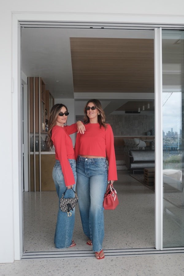 The Dodger Button Sneak Wipeout by MOTHER, trendy mid-blue jeans with a slouchy fit, loose straight leg, and a clean hem. Perfect for a relaxed look with whiskering and knee fading, made from rigid SUPERIOR denim.