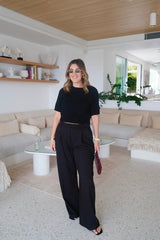 Niamh Knit Top Black by Sneaky Link – A chic cropped knit with a high scoop neckline and ribbed details. Perfectly blends comfort and style for versatile daywear.