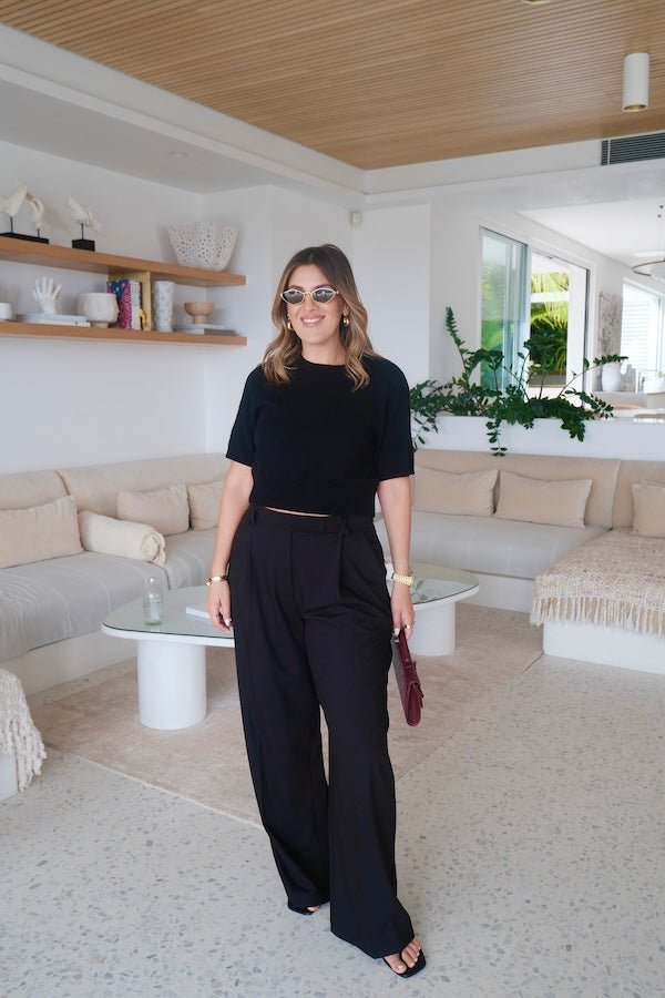 Niamh Knit Top Black by Sneaky Link – A chic cropped knit with a high scoop neckline and ribbed details. Perfectly blends comfort and style for versatile daywear.