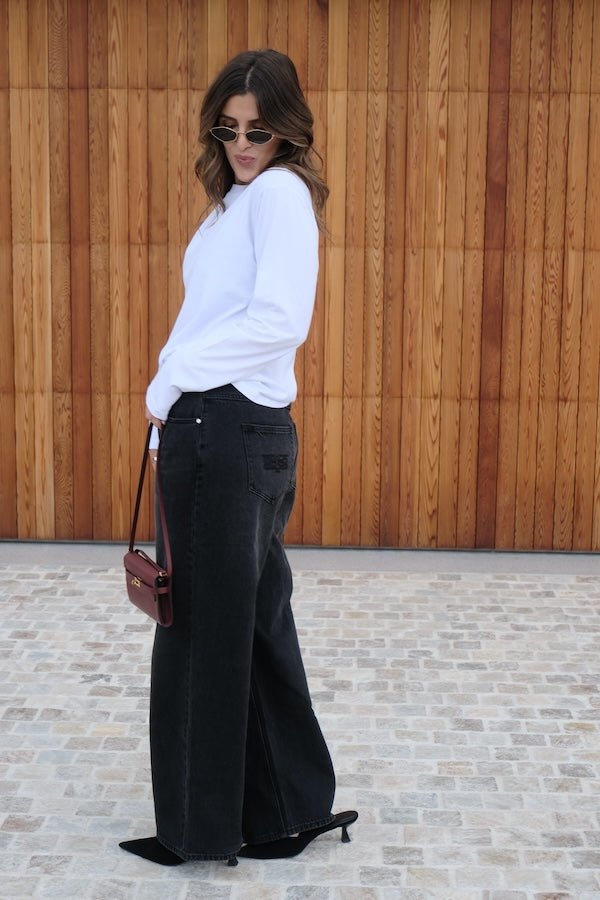 Elisha Baggy Jean Black by Sneaky Link, relaxed mid-rise cotton jeans with branded hardware and signature embroidery. Size down if between sizes.