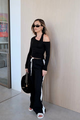 Issy Long Sleeve Top Black by Sneaky Link – Luxuriously soft modal-spandex with an off-shoulder neckline and built-in halter for support. Delicate fabric; handle gently. Cold hand wash.