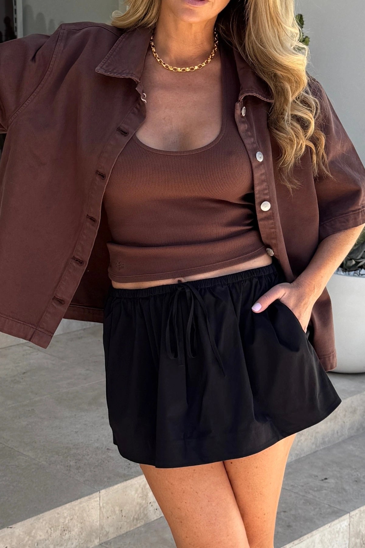 Dante Mini Skirt in Black by Bec + Bridge, a gathered stretch mini with drawstring waist. Perfect for relaxed everyday styling.