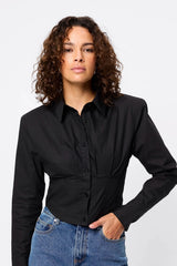 Darcy Shirt in Black by Mossman, a structured cropped cotton shirt with shoulder pads and exposed button front.