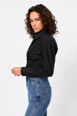 Darcy Shirt in Black by Mossman, a structured cropped cotton shirt with shoulder pads and exposed button front.