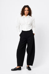 Darcy Shirt in White by Mossman, a structured cropped cotton shirt with shoulder pads and exposed button front.