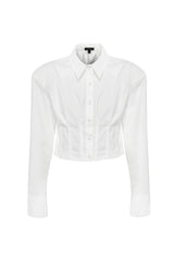 Darcy Shirt in White by Mossman, a structured cropped cotton shirt with shoulder pads and exposed button front.