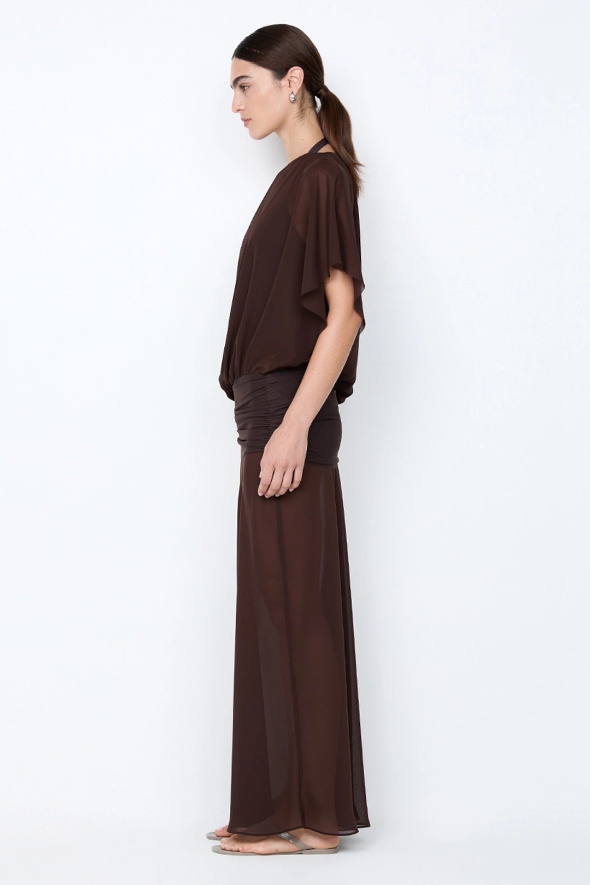Delilah Overlay Dress in Dark Chocolate by Bec + Bridge, an off-shoulder sheer georgette maxi with removable slip for versatile, elegant occasions.