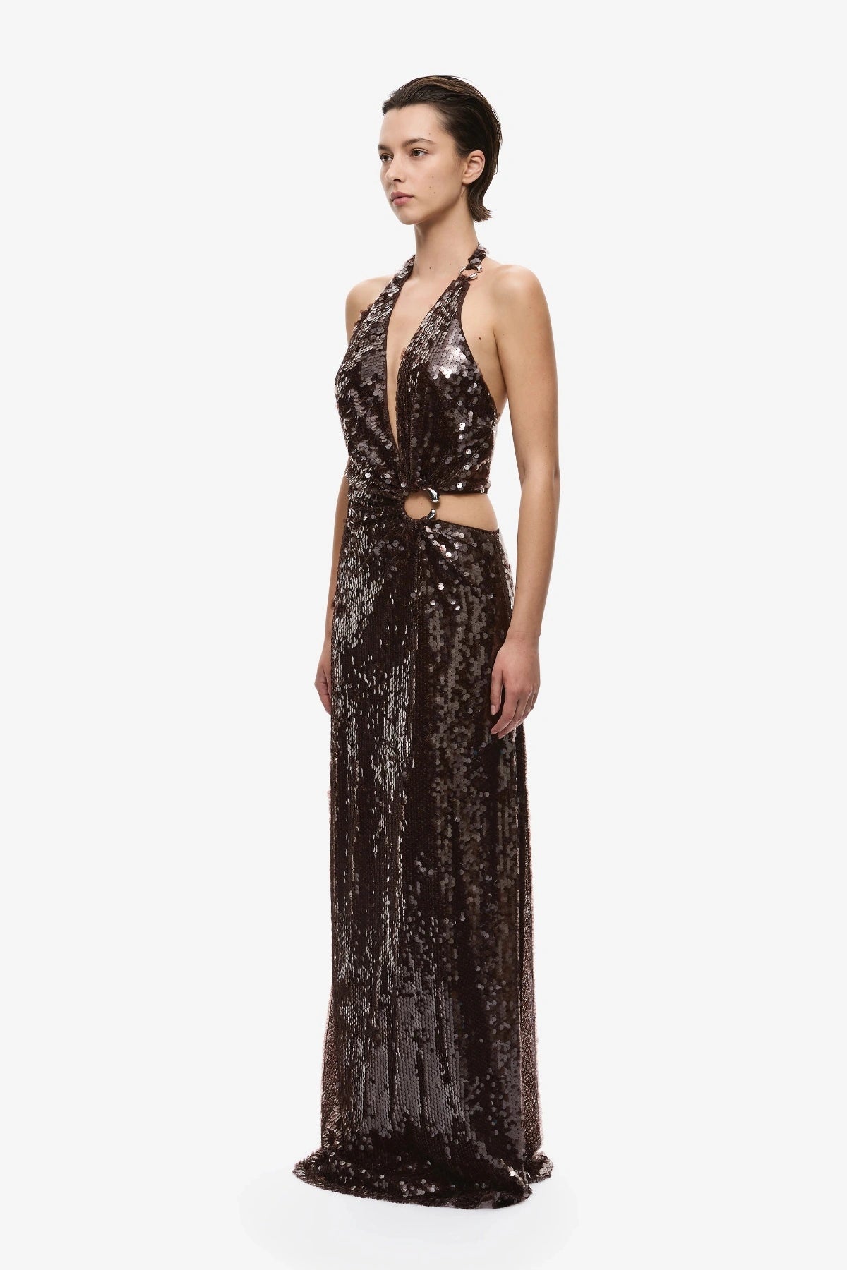 Devon Sequin Dress Chocolate by Misha, an asymmetric plunge sequin gown with metal ring details and an open back for dramatic evening wear.
