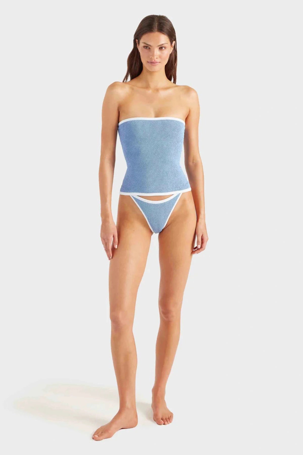 Devyn Swimskirt by Hunza G, a crinkle-textured piece worn as a tube top or skirt. Perfect for beach layering or versatile summer styling.