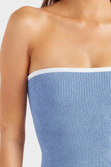 Devyn Swimskirt by Hunza G, a crinkle-textured piece worn as a tube top or skirt. Perfect for beach layering or versatile summer styling.