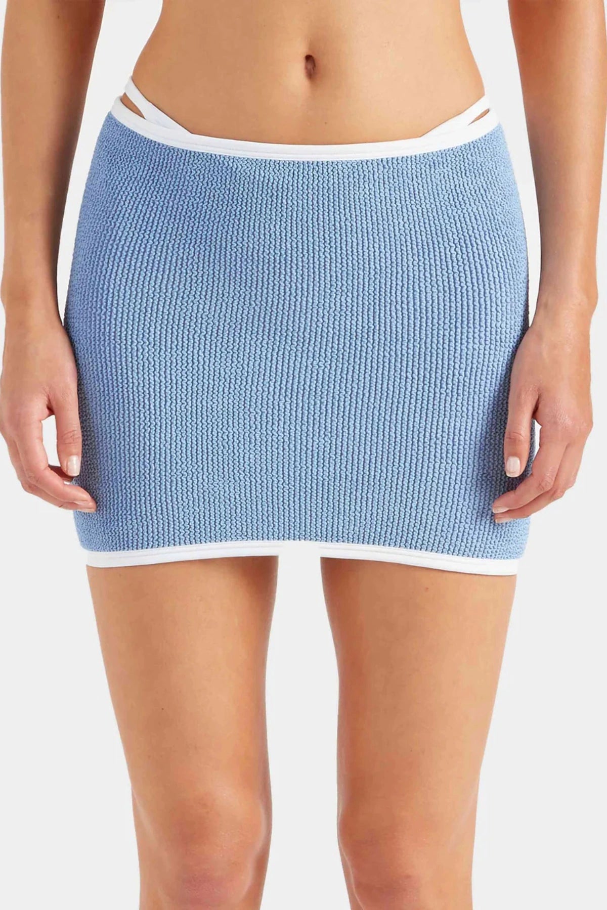 Devyn Swimskirt by Hunza G, a crinkle-textured piece worn as a tube top or skirt. Perfect for beach layering or versatile summer styling.