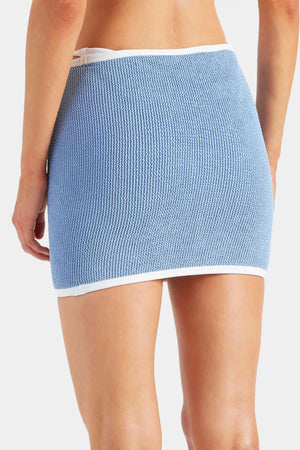 Devyn Swimskirt by Hunza G, a crinkle-textured piece worn as a tube top or skirt. Perfect for beach layering or versatile summer styling.