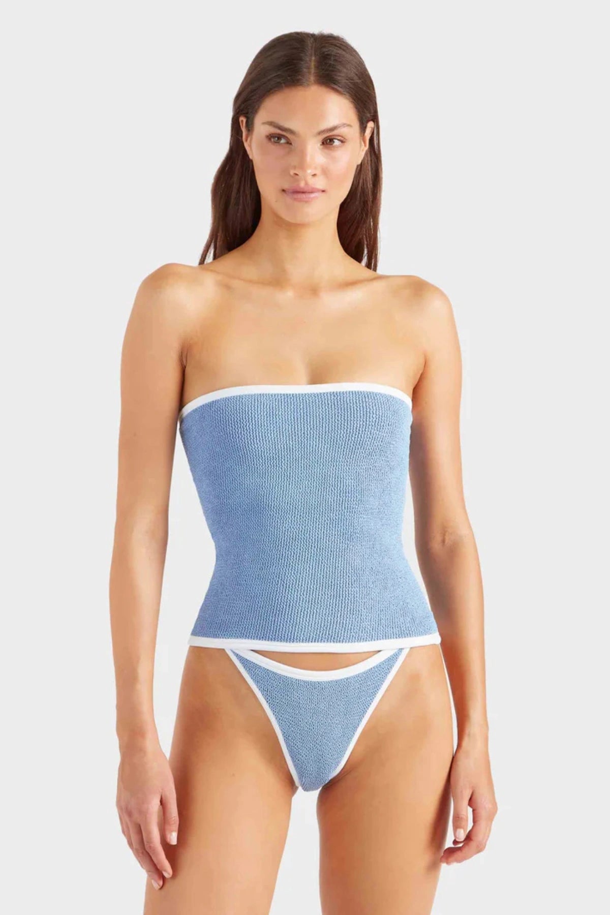 Devyn Swimskirt by Hunza G, a crinkle-textured piece worn as a tube top or skirt. Perfect for beach layering or versatile summer styling.