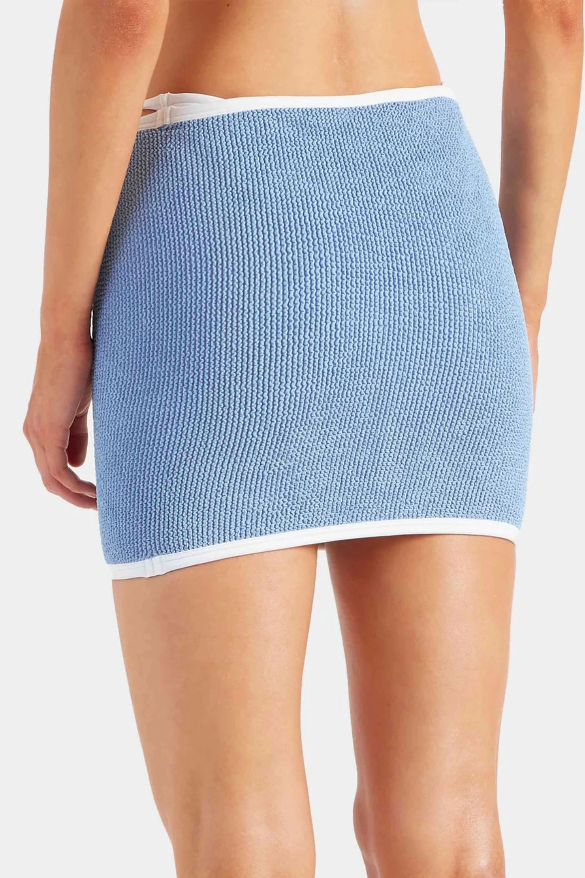 Devyn Swimskirt by Hunza G, a crinkle-textured piece worn as a tube top or skirt. Perfect for beach layering or versatile summer styling.