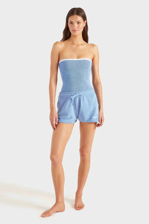 Devyn Swimskirt by Hunza G, a crinkle-textured piece worn as a tube top or skirt. Perfect for beach layering or versatile summer styling.