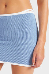 Devyn Swimskirt by Hunza G, a crinkle-textured piece worn as a tube top or skirt. Perfect for beach layering or versatile summer styling.