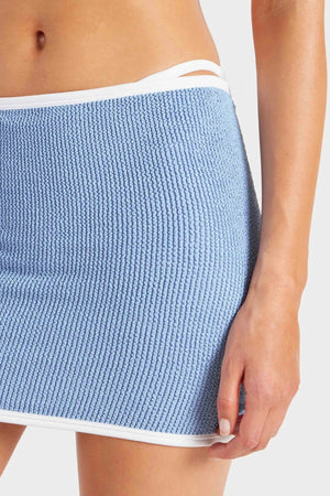 Devyn Swimskirt by Hunza G, a crinkle-textured piece worn as a tube top or skirt. Perfect for beach layering or versatile summer styling.