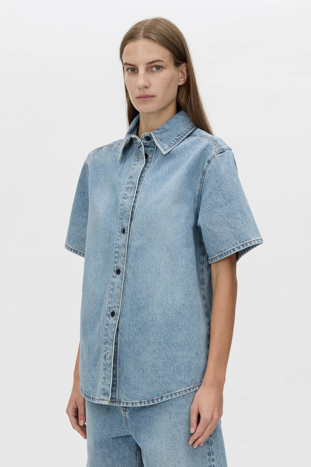 Diego Denim Shirt by Camilla and Marc — a light vintage blue short-sleeve denim shirt with a boxy fit and branded buttons.