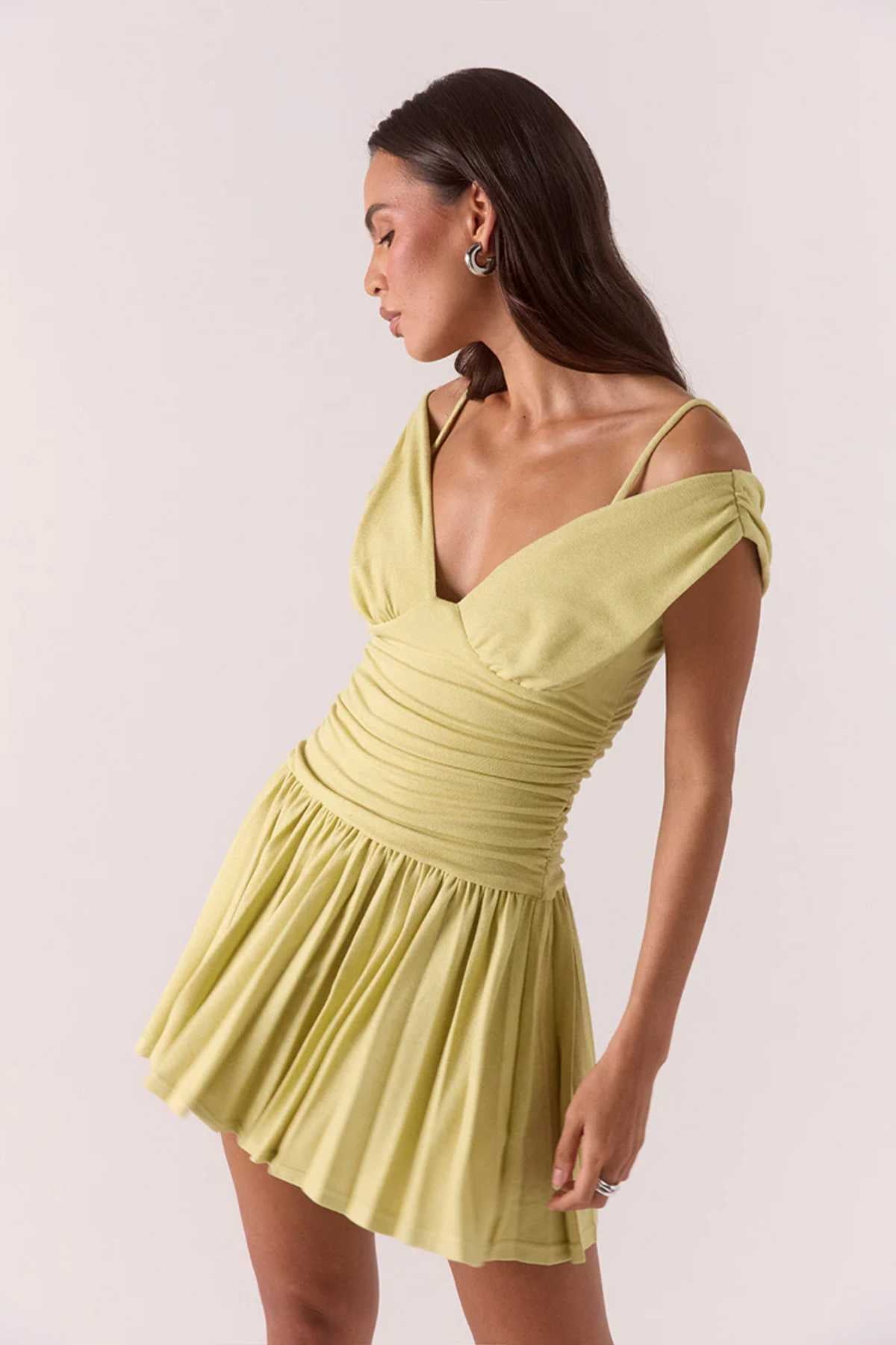Dione Mini Dress Apple by Sovere, vibrant dropped-waist mini with layered bralette, gathered bodice, and pleated skirt for sculptural feminine flair.