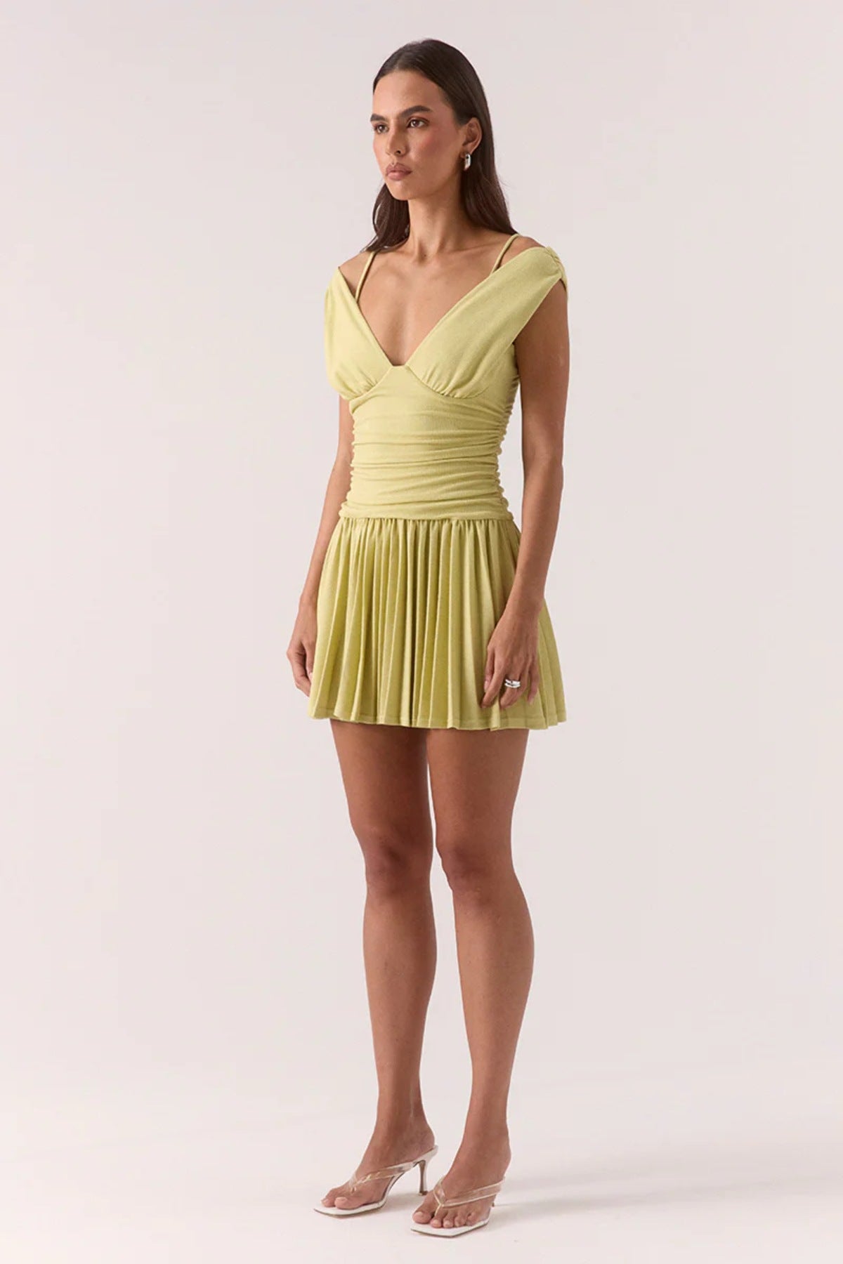 Dione Mini Dress Apple by Sovere, vibrant dropped-waist mini with layered bralette, gathered bodice, and pleated skirt for sculptural feminine flair.