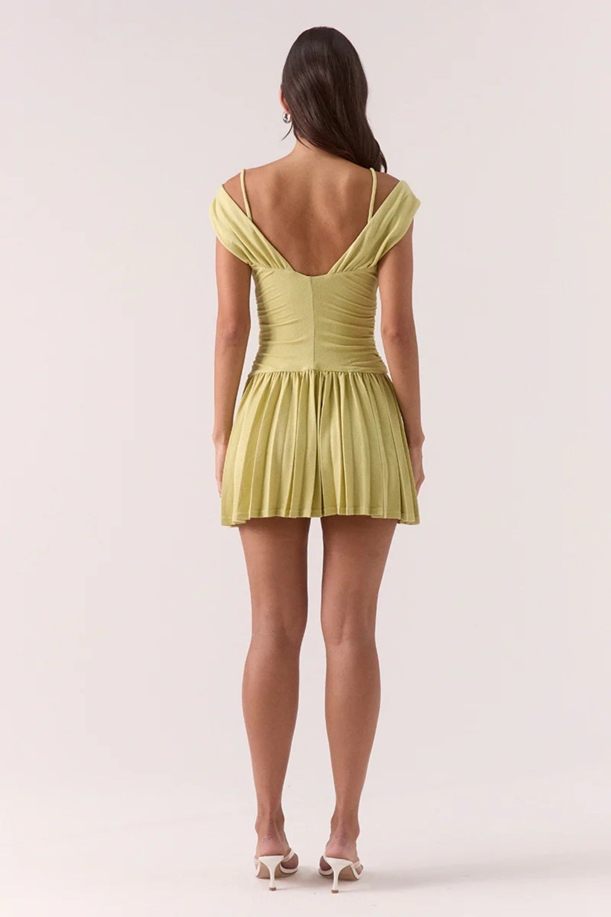 Dione Mini Dress Apple by Sovere, vibrant dropped-waist mini with layered bralette, gathered bodice, and pleated skirt for sculptural feminine flair.