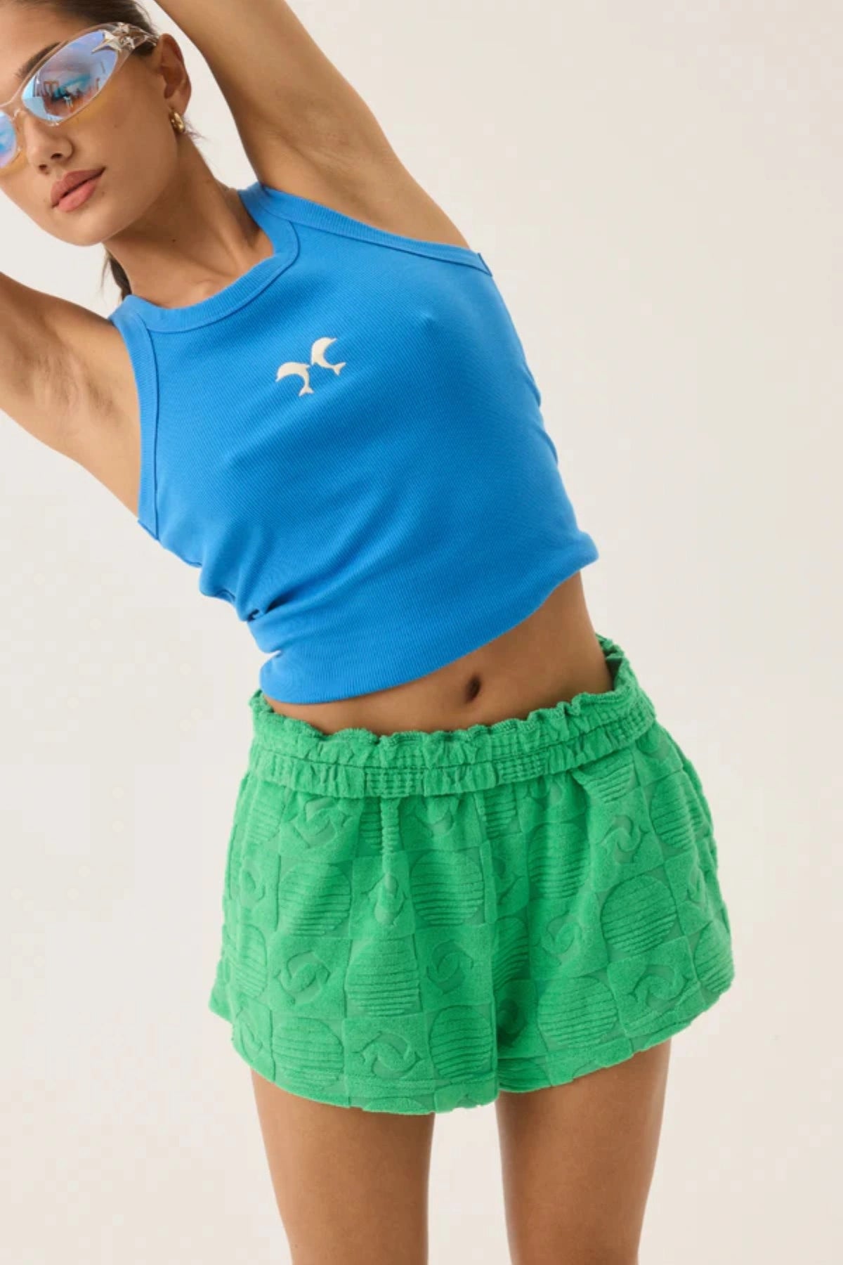 Dolphine Tank by Araminta James — a French Blue ribbed racer tank with dolphin embroidery, perfect for warm-weather casual styling.