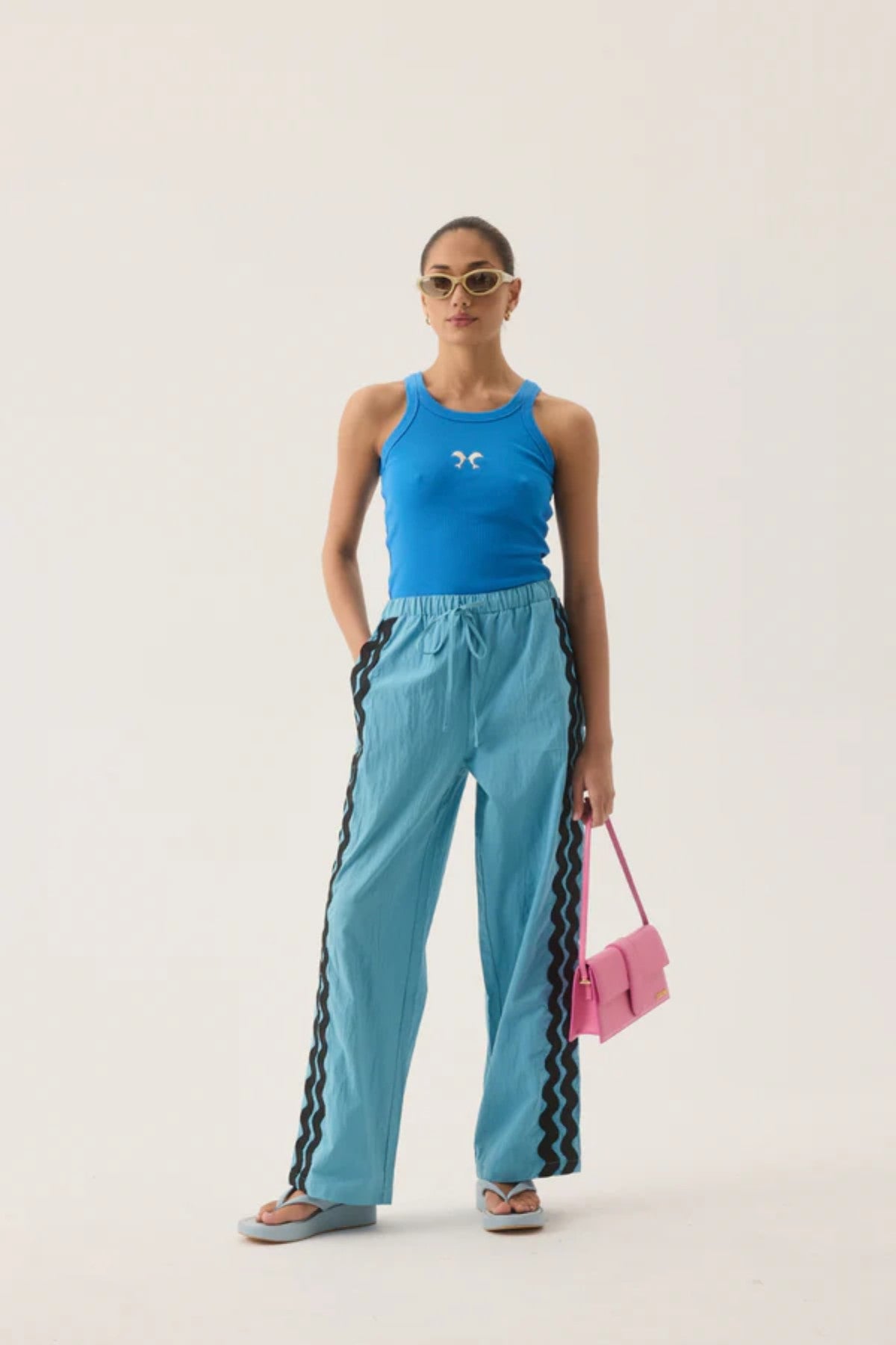 Dolphine Tank by Araminta James — a French Blue ribbed racer tank with dolphin embroidery, perfect for warm-weather casual styling.