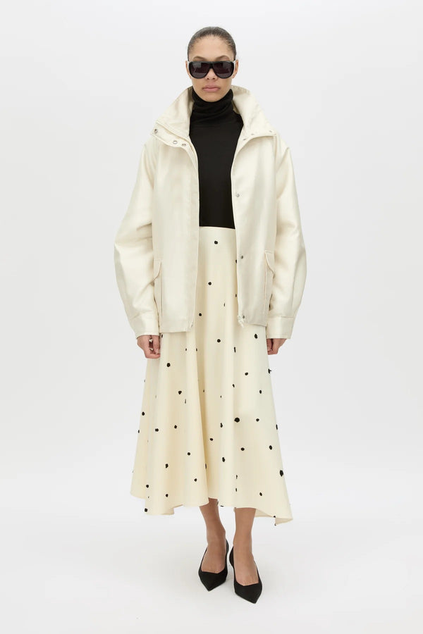 Drea Puffer Jacket by Camilla and Marc, a cream funnel-neck puffer with waist belt, raglan sleeves and detachable throat latch.