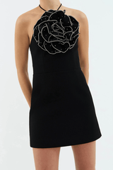 Eliana Mini Dress Black by Rebecca Vallance – A halter mini with floral appliqué, silver accents, and scoop back, perfect for romantic dinners or chic celebrations.