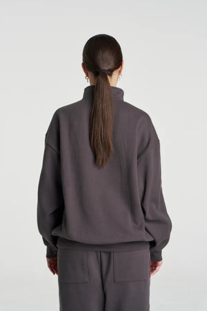 Eden Zip Neck Jumper Shadow by Summi Summi – acid wash cotton jumper with zip neck and plaid trim details.