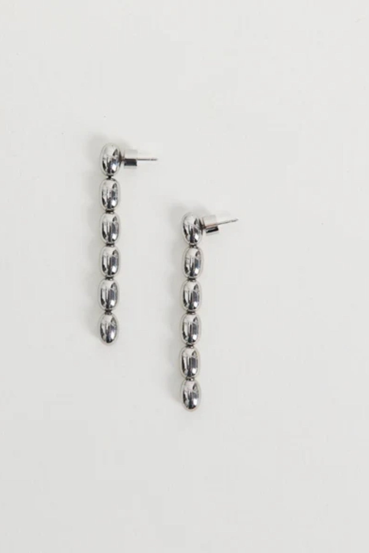 Edith Earrings in Silver by Heaven Mayhem – gold twisted-bead drop earrings with sculptural movement and shine, perfect for refined everyday styling.