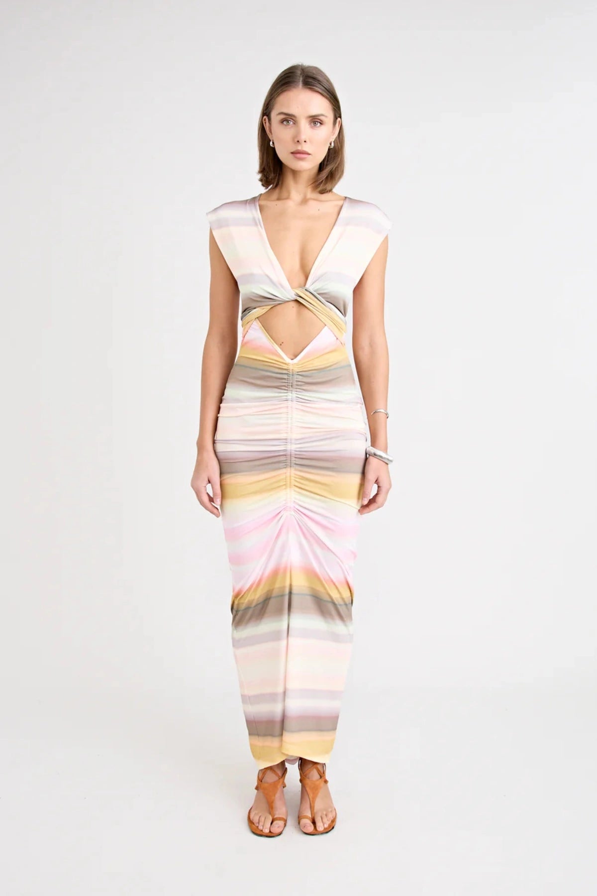 Elara Dress by Pfeiffer — a peach-toned stretch jersey midi with adjustable ties and front ruching for a custom, flattering silhouette.