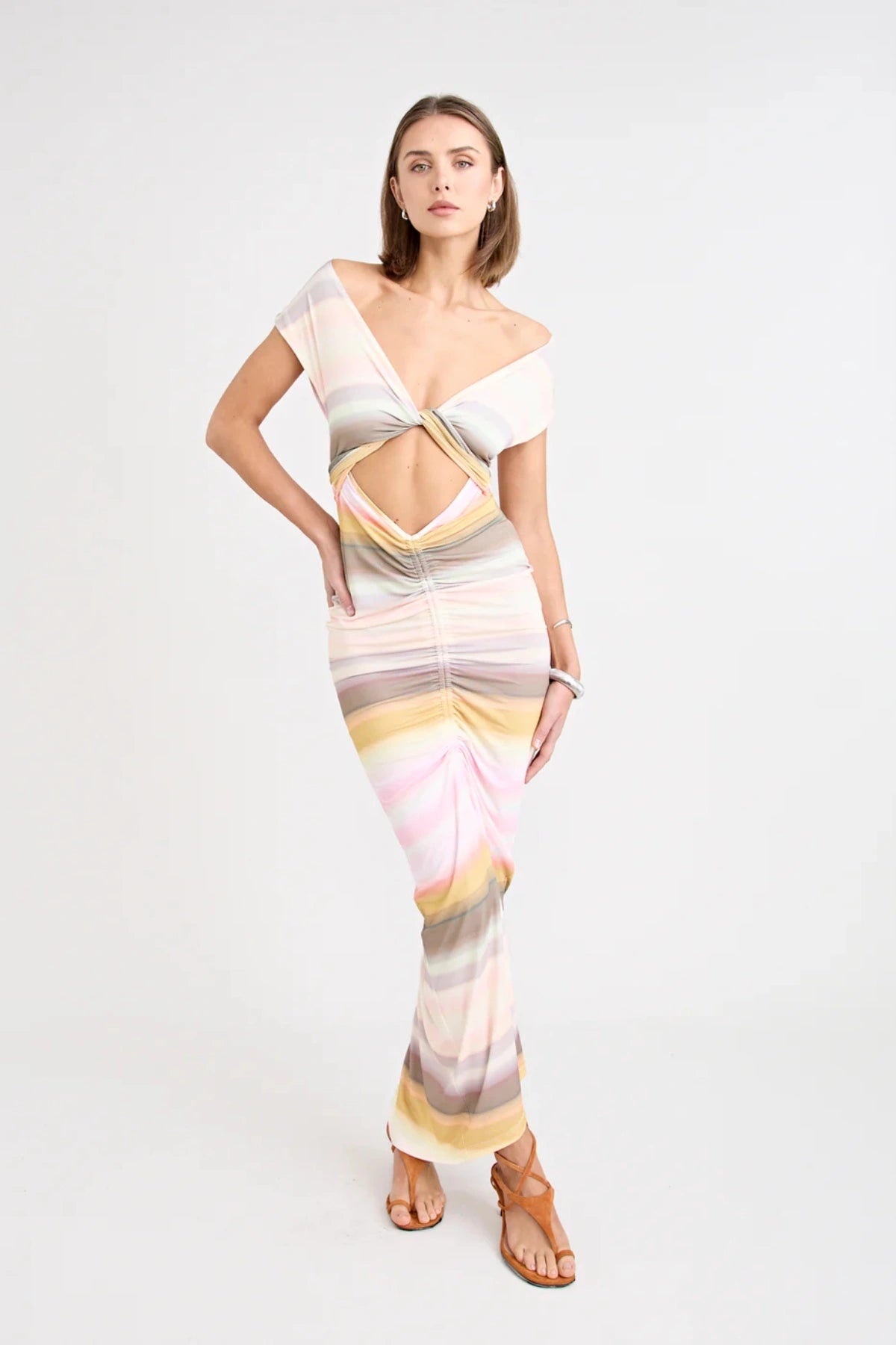 Elara Dress by Pfeiffer — a peach-toned stretch jersey midi with adjustable ties and front ruching for a custom, flattering silhouette.