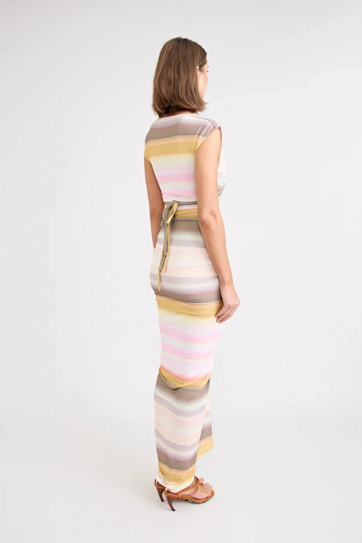 Elara Dress by Pfeiffer — a peach-toned stretch jersey midi with adjustable ties and front ruching for a custom, flattering silhouette.